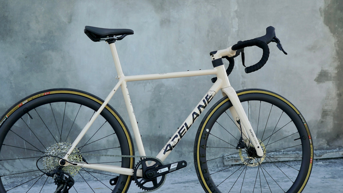 A white bike with a yellow stripe on the front wheel